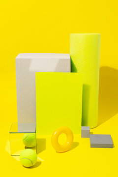 Bright neon yellow still life image of geometric objects of materials
