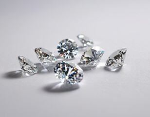 Several sparkling diamonds are displayed on a table, reflecting light and showcasing their brilliance