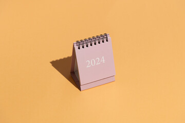 2024 calendars on orange/peach background