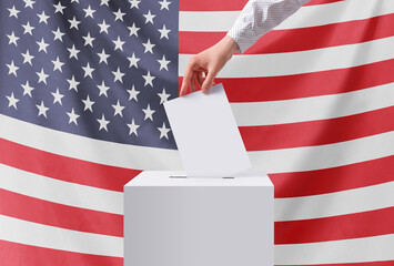 Elections, USA. A hand throws a ballot into the ballot box. USA flag. The concept of democracy....