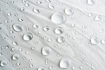 Water droplets on a gray background. Abstract natural background of drops. Water drops on waterproof fabric background.