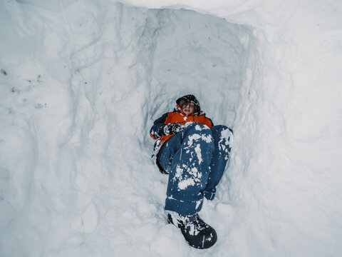 boy in snow cave