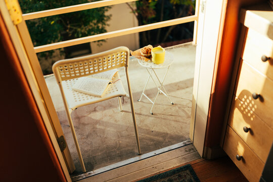 journaling on a small patio with a muffin and matcha for breakfast