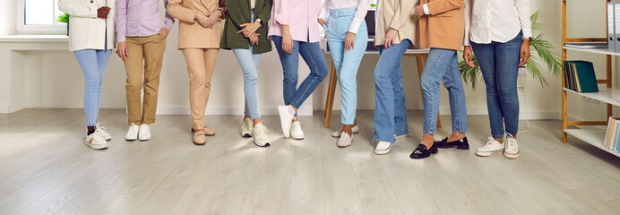Legs of a group of unrecognizable business people women standing in a row at the office on...
