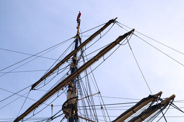 Sailing masts on the blue sky, detail of a historic ancient ship