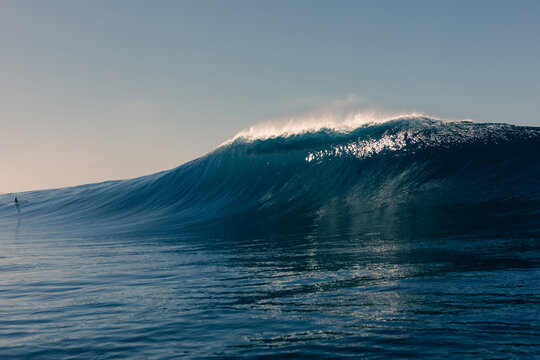 A seascape captures the dramatic moment of a colossal wave rising up