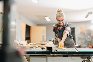 In a bustling carpenter's shop, a young woman craftsman expertly navigates her workshop, merging traditional woodwork skills with modern equipment to create hand-made furniture