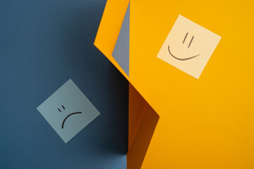Paper cards with various emoticons on a colored background, banner and place for text. Conceptual image of positive thinking and satisfaction level