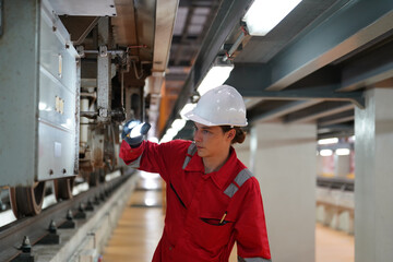 Professional technician worker hold light tube to check and maintenance part of train in electrical or metro train factory. - 789572021