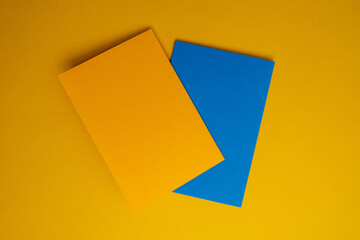Paper yellow and blue envelopes on a color background. New mail, write a message. Send and receive mail. Postal delivery service. Empty envelope, empty space. Envelope close-up 