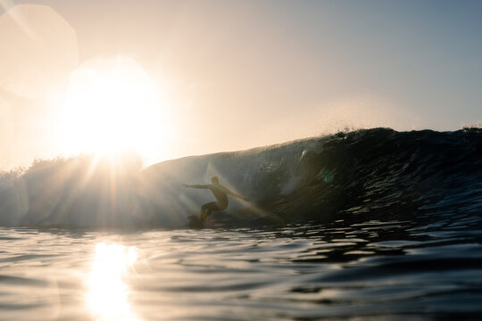 A skilled surfer successfully navigating a massive wave