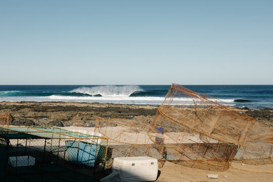 El Quemao, Lanzarote with crashing waves and fishing cages piled up.