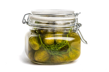 A closed glass home canning jar of baby dill pickles isolated on white