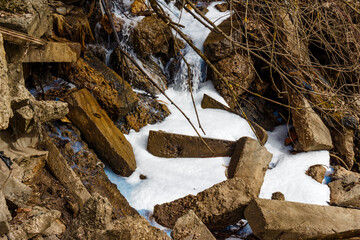 Illegal drainage of technical fluid into a ravine forming white foam - obrazy, fototapety, plakaty