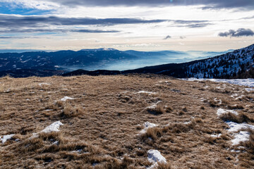 Scenic hiking trail over snow covered alpine meadow between Gertrusk and Ladinger Spitz, Saualpe,...