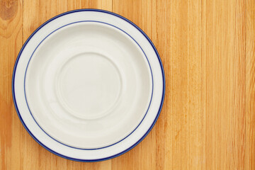 Empty plate on a wood table