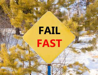 Fail fast symbol. Concept words Fail fast on beautiful yellow road sign. Beautiful forest snow blue...