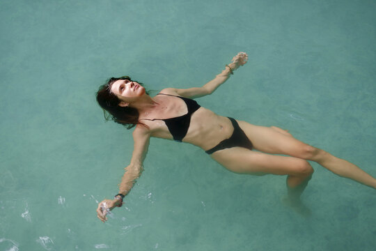 Serene Underwater Woman Floating in Clear Water
