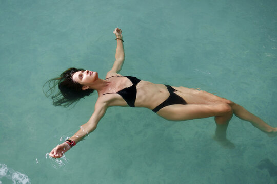 Serene Underwater Woman Floating in Clear Water