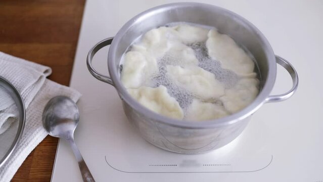 Close up cooking dumpling in boiling water. Cooking traditional Chinese food during Spring Festival