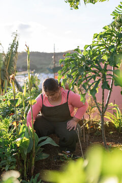 Woman with Down syndrome crouching.
