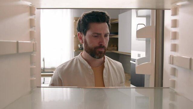 POV point of view from inside refrigerator Caucasian hungry funny man adult confused male guy looking in empty fridge no food without products close suddenly open door again wish miracle meal appear