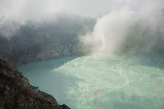 Scenic view of a blue acid lake in volcano's crater