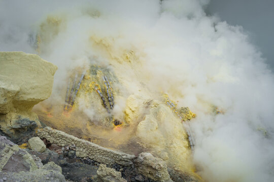 Sulfur open mine in an active volcano crater, toxic gas and ore