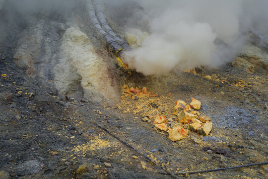 Sulfur open mine in an active volcano crater, toxic gas and ore