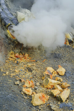 Sulfur open mine in an active volcano crater, toxic gas and ore