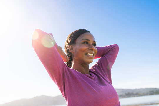 Happy woman hands behind head