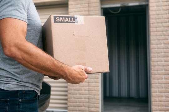 Storage: Man Putting Box Into Empty Storage Facility