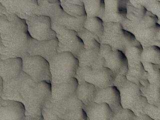 Gray volcanic sand texture after rainy and windy weather, El Medano, Tenerife, Canary Islands, Spain