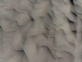 Gray volcanic sand texture after rainy and windy weather, El Medano, Tenerife, Canary Islands, Spain