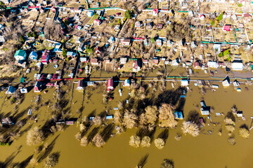 Dacha plots with houses flooded during heavy floods in spring, view from a drone