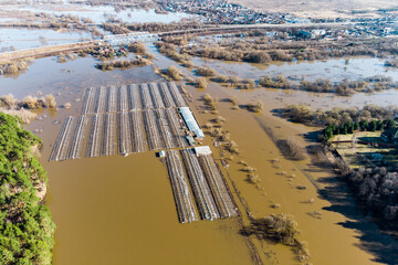 Farmland flooded with water during a strong river flood in spring, view from a high altitude