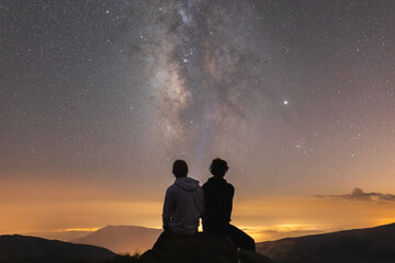 Friends enjoying night sky in the mountains
