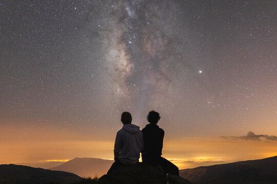 Friends enjoying night sky in the mountains