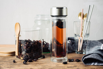 Rosehip tea in a bottle and dried rosehips.