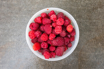 Raspberries in a container, top view.