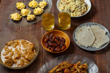 set table meat bread fruits for iftar meal in Ramadan