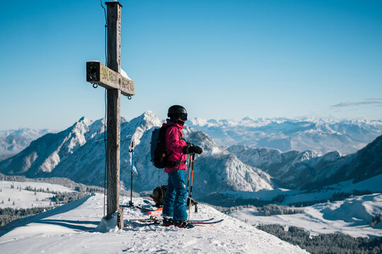 ski tourer on summit overlooking the alps