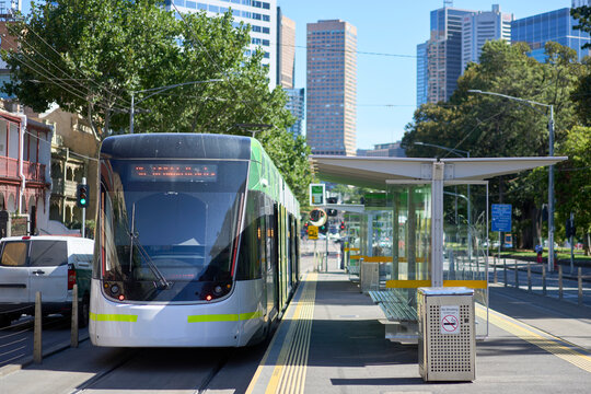 Melbourne tram with city buildings in background.
