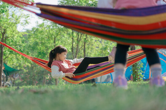 Asian kid hanging out in hammock