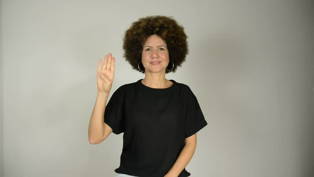 Female interpreter says the alphabet in Brazilian sign language.
