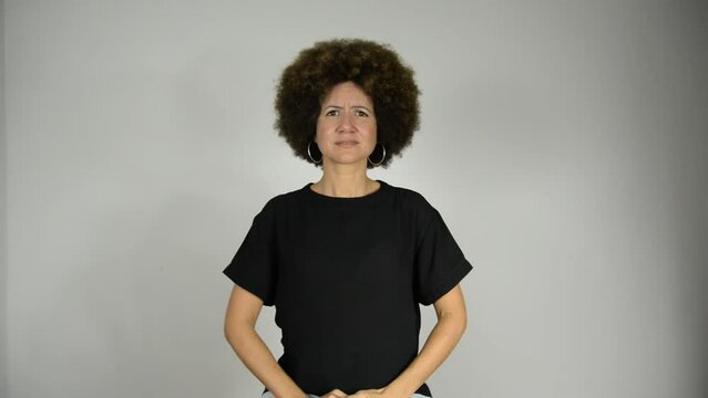 Female interpreter saying stop the genocide in Brazilian sign language.