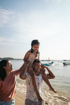 Balinese family having fun at the beach