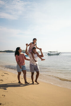 Happy family enjoying the weekend at the beach