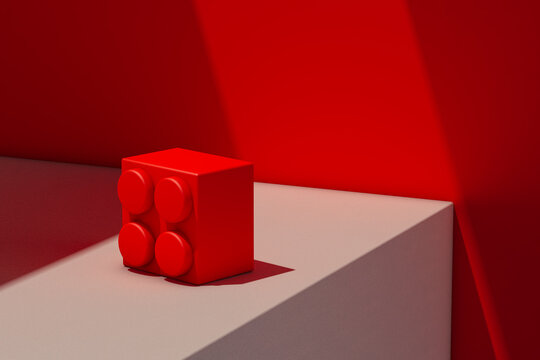 Red block of plastic on White Surface