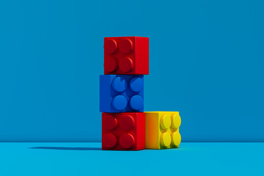 Stack of plastic blocks on blue surface